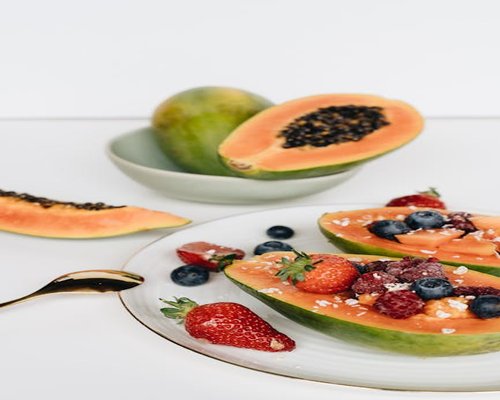 A colorful plate of fresh fruits featuring local Colombian avocado, papaya and simple balanced food ingredients