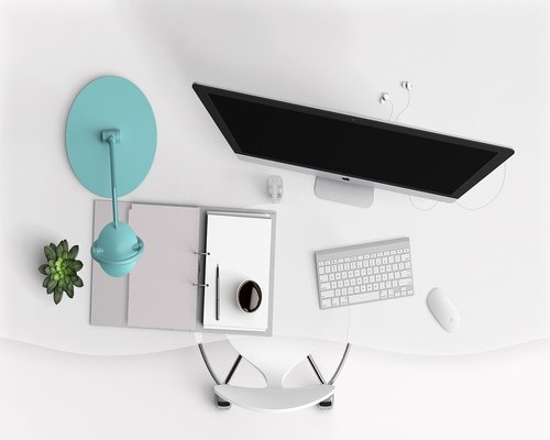A neat and organized minimalist wooden workspace at dusk without any digital screens turned on